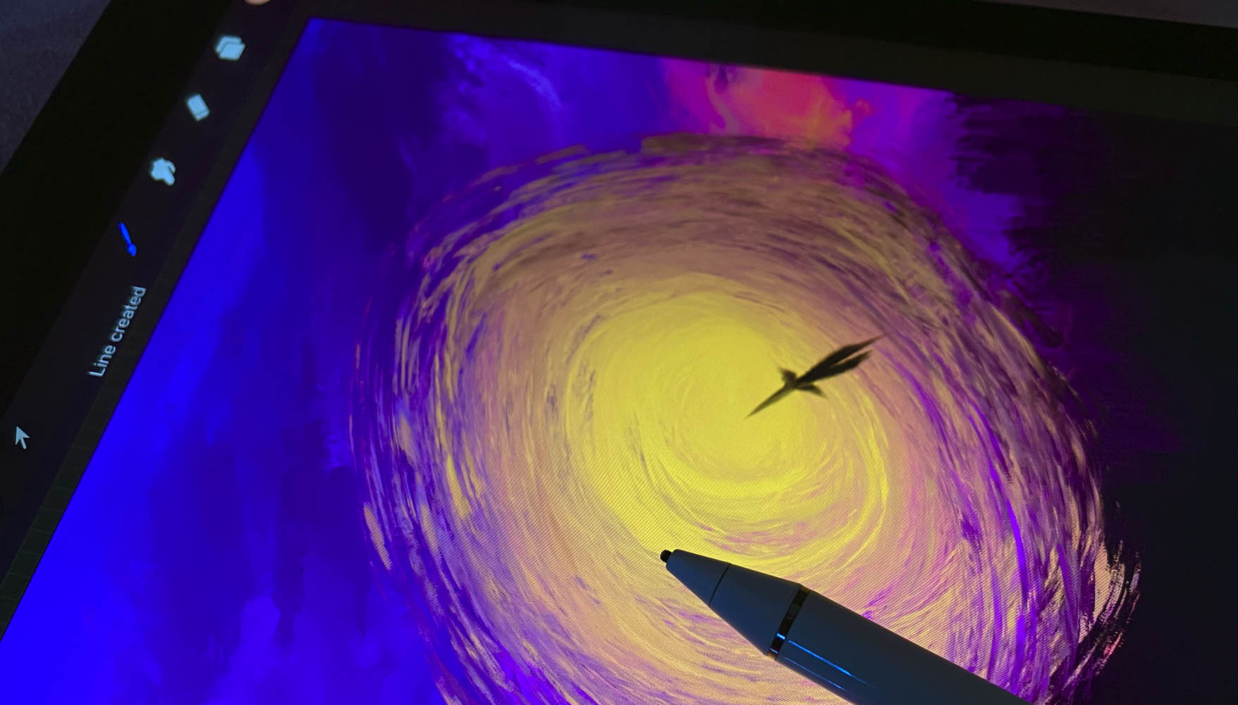 A person using iPad and Apple Pencil with something scribbed in Procreate app