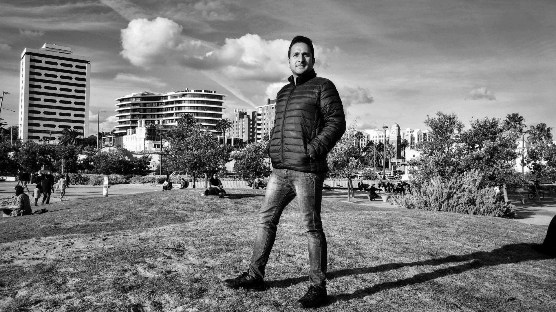Swapnil standing on a grassy park near St. Kilda Beach